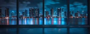 a sleek and modern miami condo interior showcases panoramic views of the vibrant city skyline, highlighted by shimmering ocean reflections and contemporary furnishings, exuding a luxurious lifestyle.